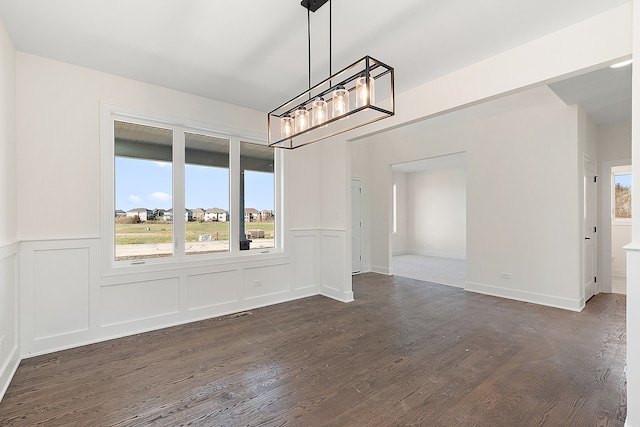 unfurnished dining area with dark hardwood / wood-style floors