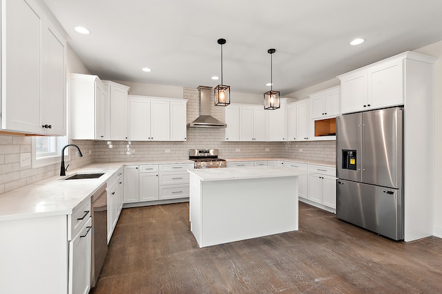 kitchen featuring a center island, sink, wall chimney exhaust hood, dark hardwood / wood-style flooring, and stainless steel appliances