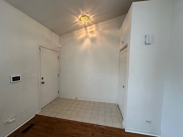 unfurnished room with light wood-type flooring