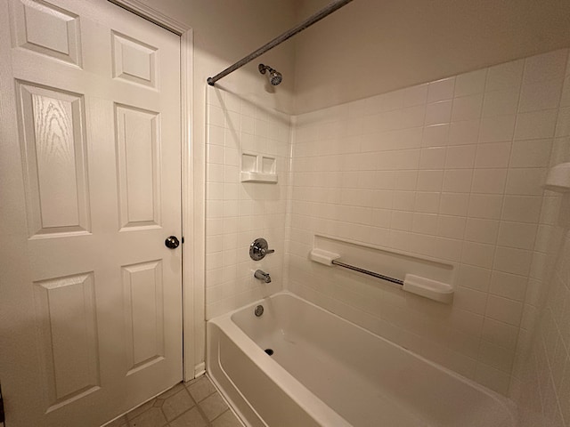 bathroom with tile patterned floors and tiled shower / bath combo