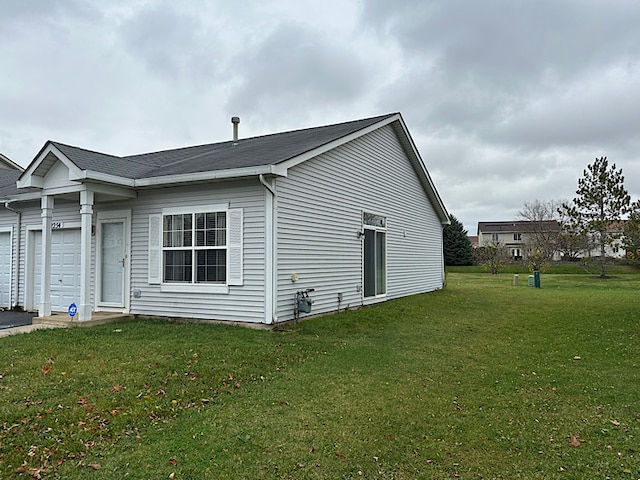 view of home's exterior featuring a garage and a lawn