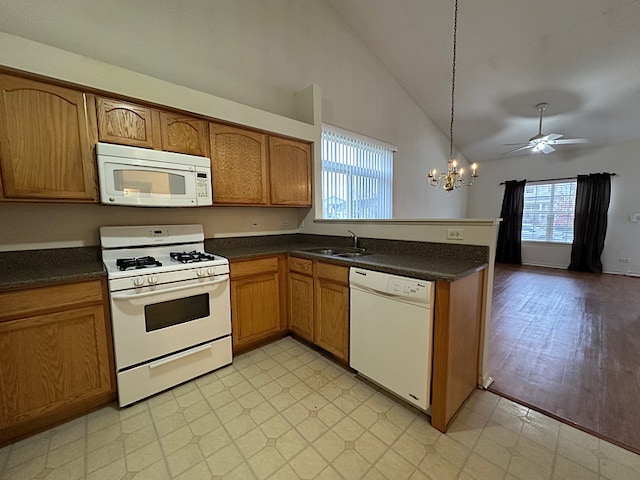 kitchen featuring plenty of natural light, ceiling fan with notable chandelier, light hardwood / wood-style floors, and white appliances