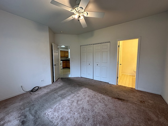 unfurnished bedroom with carpet flooring, ceiling fan, and a closet