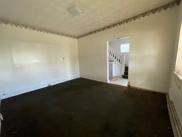 unfurnished room with a baseboard radiator