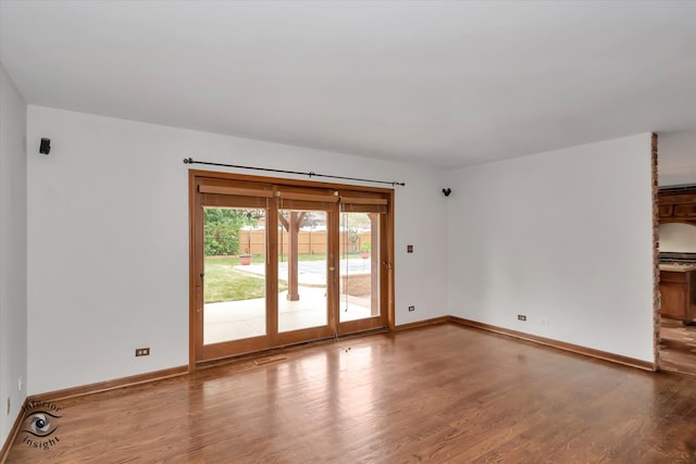 unfurnished room featuring hardwood / wood-style flooring