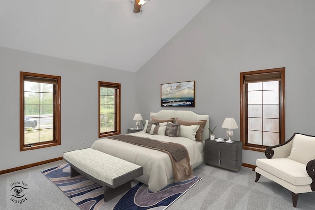 bedroom featuring light carpet and high vaulted ceiling