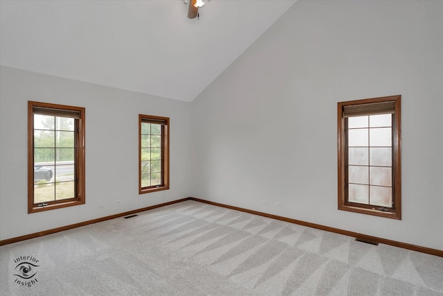 unfurnished room featuring ceiling fan, light carpet, and high vaulted ceiling