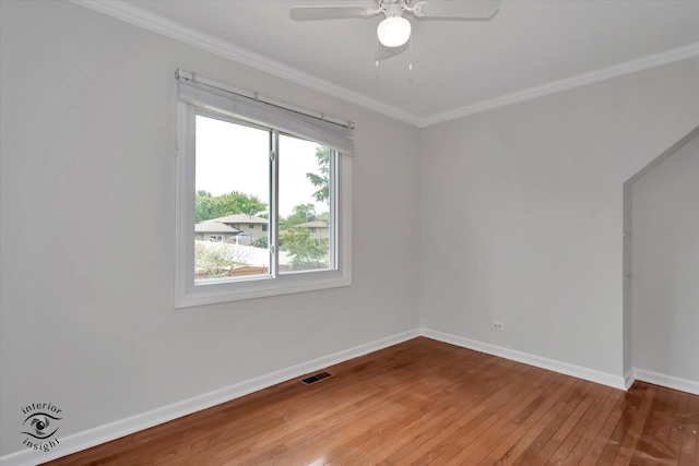 spare room with crown molding, ceiling fan, and wood-type flooring