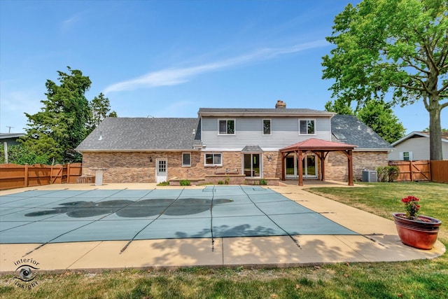 view of swimming pool with a lawn, central AC, and a patio