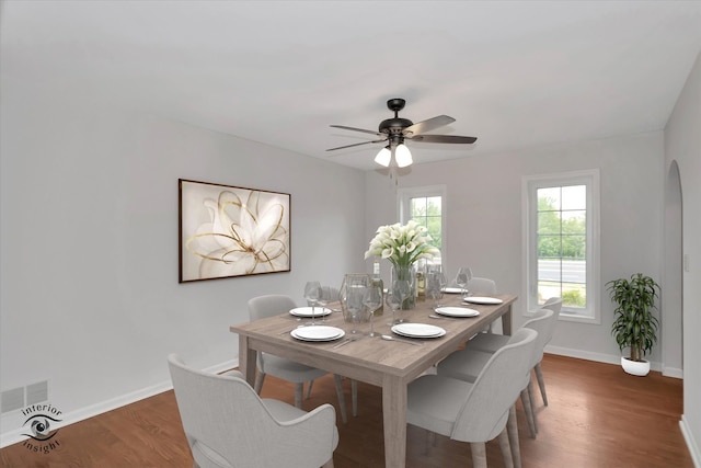 dining area featuring ceiling fan and dark hardwood / wood-style flooring