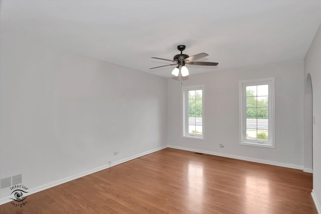 unfurnished room with hardwood / wood-style flooring and ceiling fan