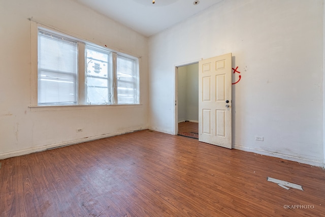 spare room with ceiling fan and wood-type flooring