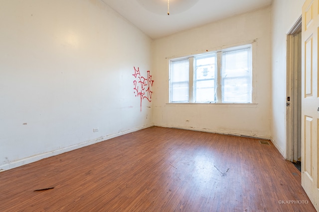 spare room featuring ceiling fan and dark hardwood / wood-style flooring