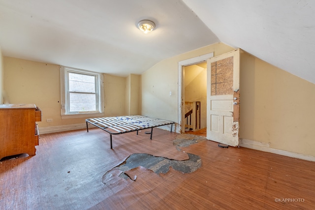 rec room featuring light hardwood / wood-style floors and lofted ceiling