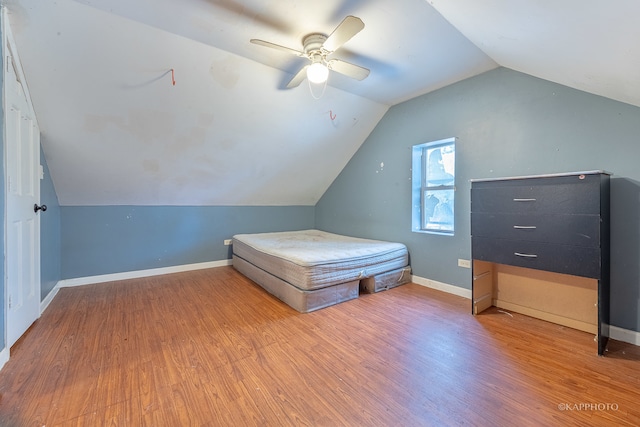 unfurnished bedroom featuring ceiling fan, hardwood / wood-style floors, and lofted ceiling