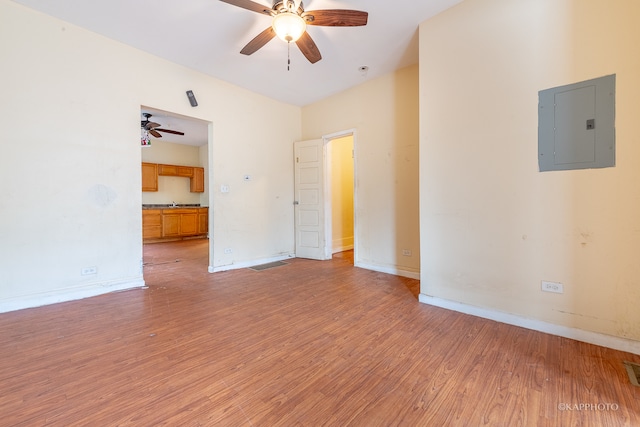 unfurnished room with hardwood / wood-style flooring, ceiling fan, and electric panel