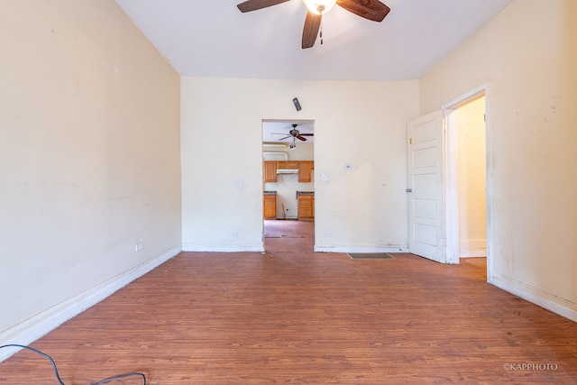 spare room featuring wood-type flooring and ceiling fan