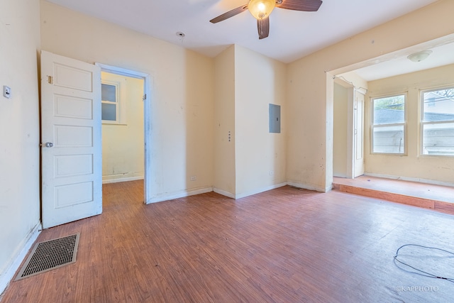 unfurnished room featuring electric panel, ceiling fan, and wood-type flooring