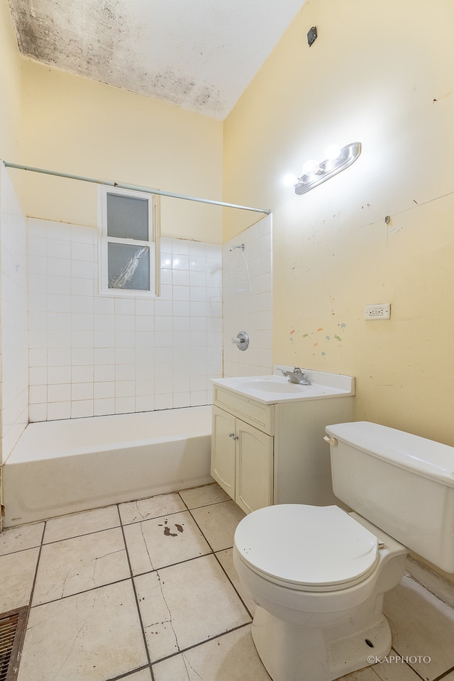 full bathroom featuring tile patterned flooring, vanity, toilet, and tiled shower / bath