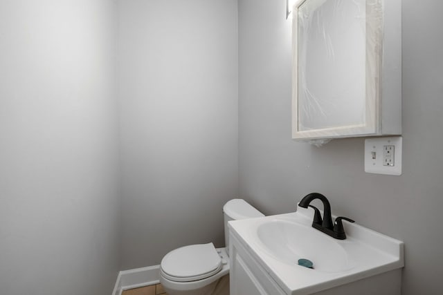 bathroom featuring tile patterned flooring, vanity, and toilet