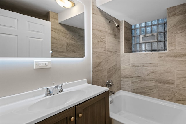 bathroom with vanity and tiled shower / bath combo