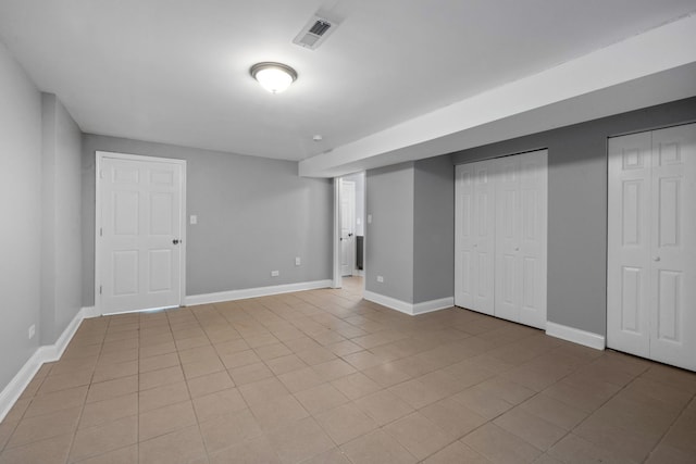 basement with light tile patterned flooring