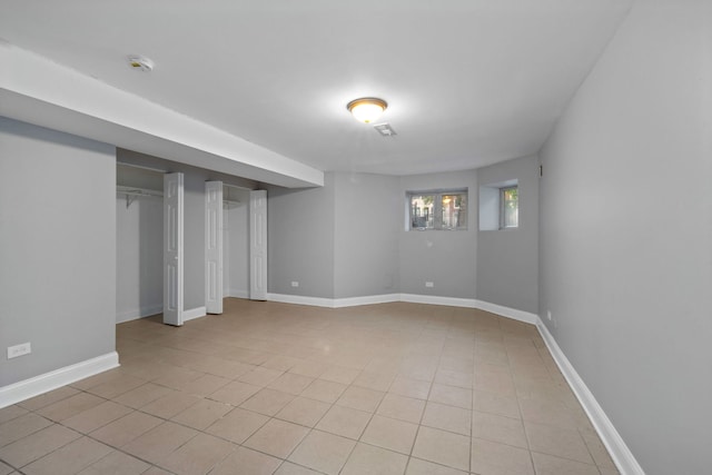 basement featuring light tile patterned flooring