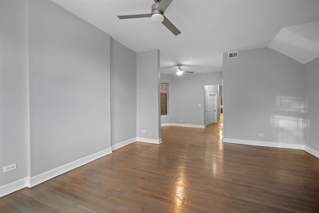 interior space featuring ceiling fan, dark wood-type flooring, and vaulted ceiling