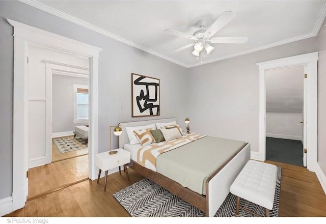 bedroom featuring hardwood / wood-style flooring, ceiling fan, and ornamental molding