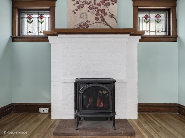 interior details featuring hardwood / wood-style flooring and a wood stove