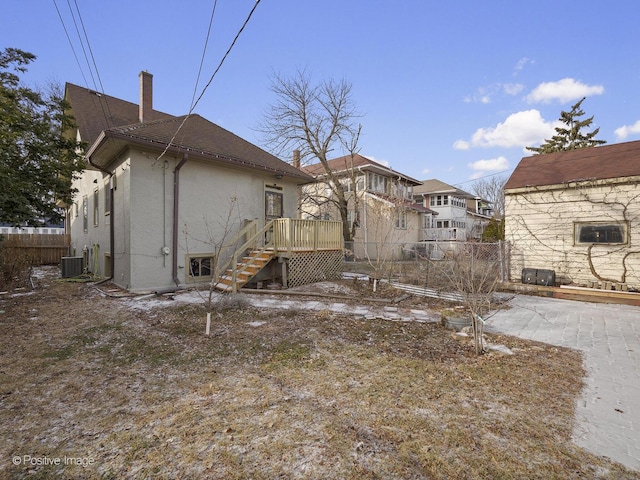 rear view of house with central air condition unit and a wooden deck