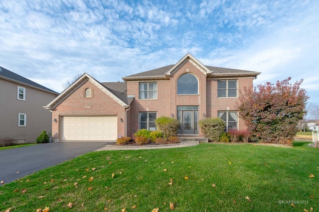 view of front of property featuring a front lawn and a garage