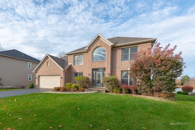 view of front of home featuring a garage and a front lawn