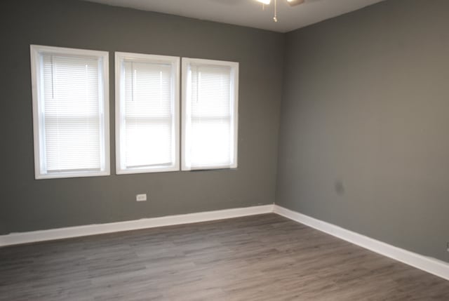 empty room with ceiling fan and hardwood / wood-style floors