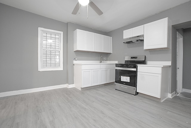 kitchen featuring ceiling fan, stainless steel range oven, extractor fan, white cabinets, and light wood-type flooring