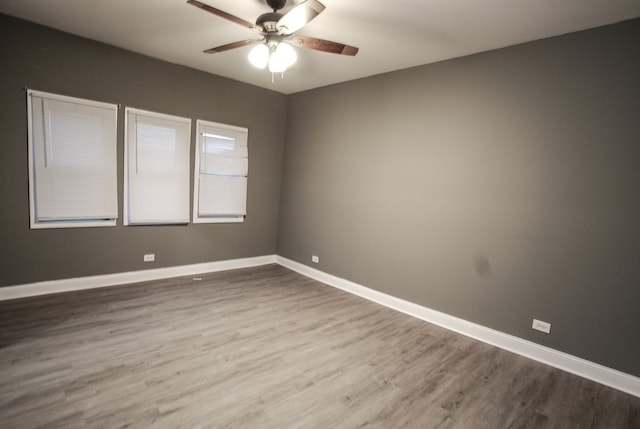 unfurnished room with hardwood / wood-style floors and ceiling fan