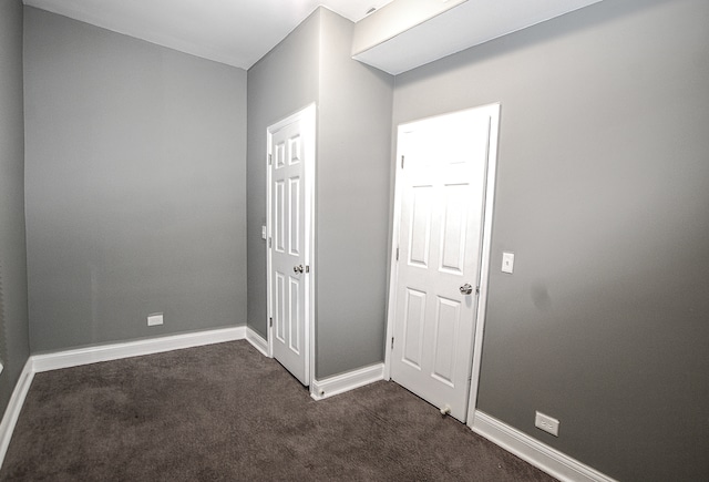 interior space with dark colored carpet