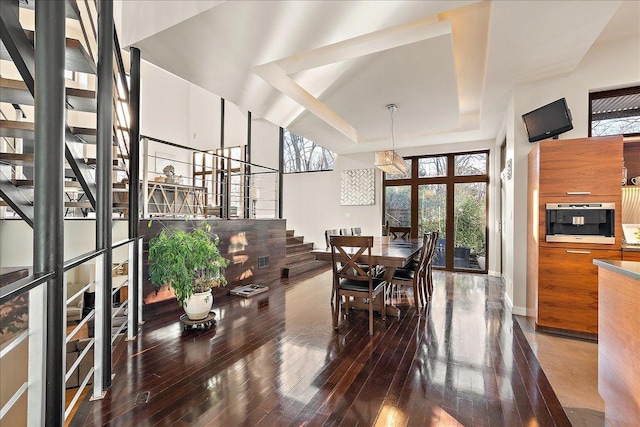 dining area with hardwood / wood-style flooring, an inviting chandelier, and a healthy amount of sunlight