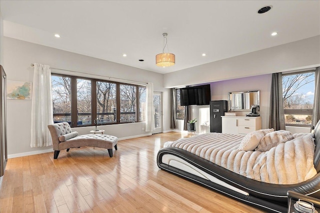 bedroom with light wood-type flooring and multiple windows