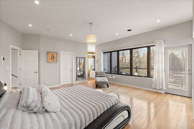 bedroom with access to exterior and light hardwood / wood-style flooring