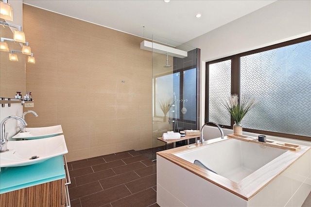 bathroom with vanity, tile walls, and independent shower and bath