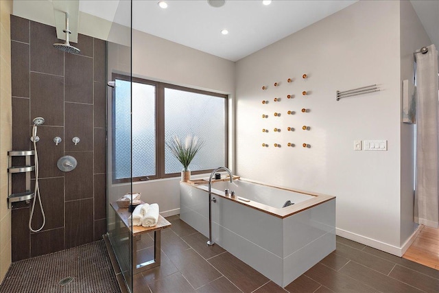 bathroom featuring shower with separate bathtub and hardwood / wood-style floors