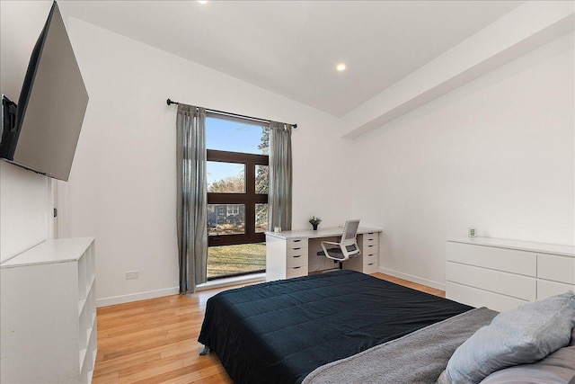 bedroom featuring vaulted ceiling and light hardwood / wood-style flooring