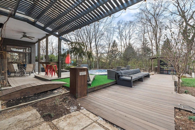 wooden deck with an outdoor living space, ceiling fan, a pergola, and a swimming pool