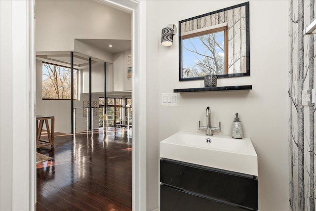 bathroom with hardwood / wood-style floors, a healthy amount of sunlight, and sink