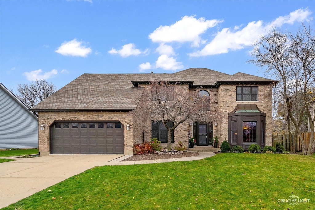 french country style house with a garage and a front lawn