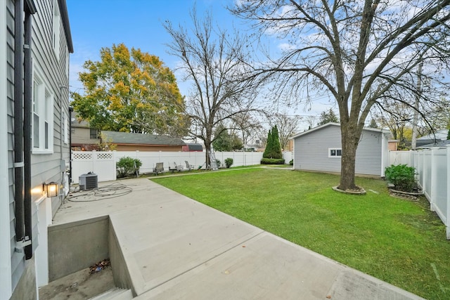 view of yard with central AC unit and a patio