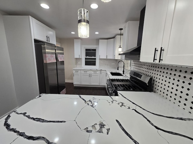 kitchen featuring light stone countertops, pendant lighting, white cabinets, appliances with stainless steel finishes, and sink