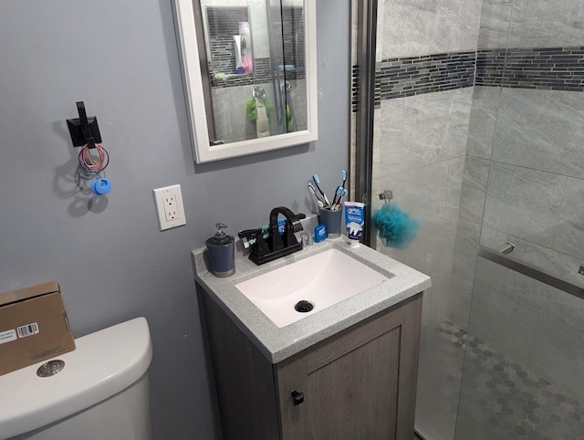 bathroom with vanity, toilet, and walk in shower