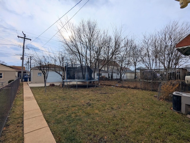 view of yard with a trampoline and central air condition unit